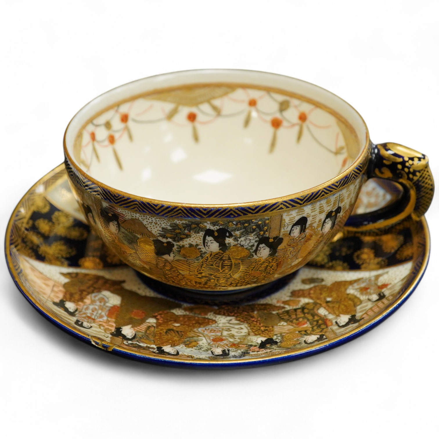 A Japanese satsuma pottery cup and saucer, saucer 14cm in diameter